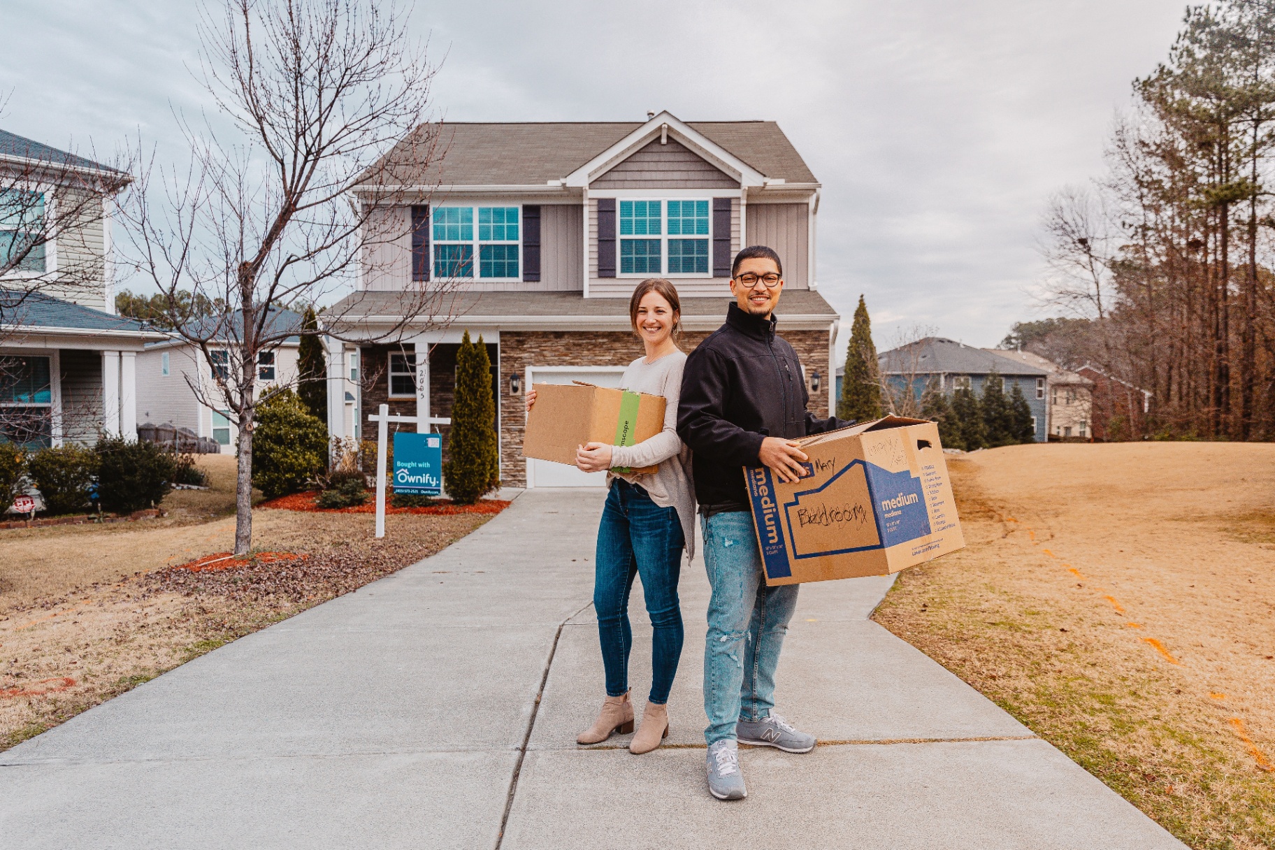 Zac and Skylar — Ownis in Raleigh standing in front of their new Ownify home